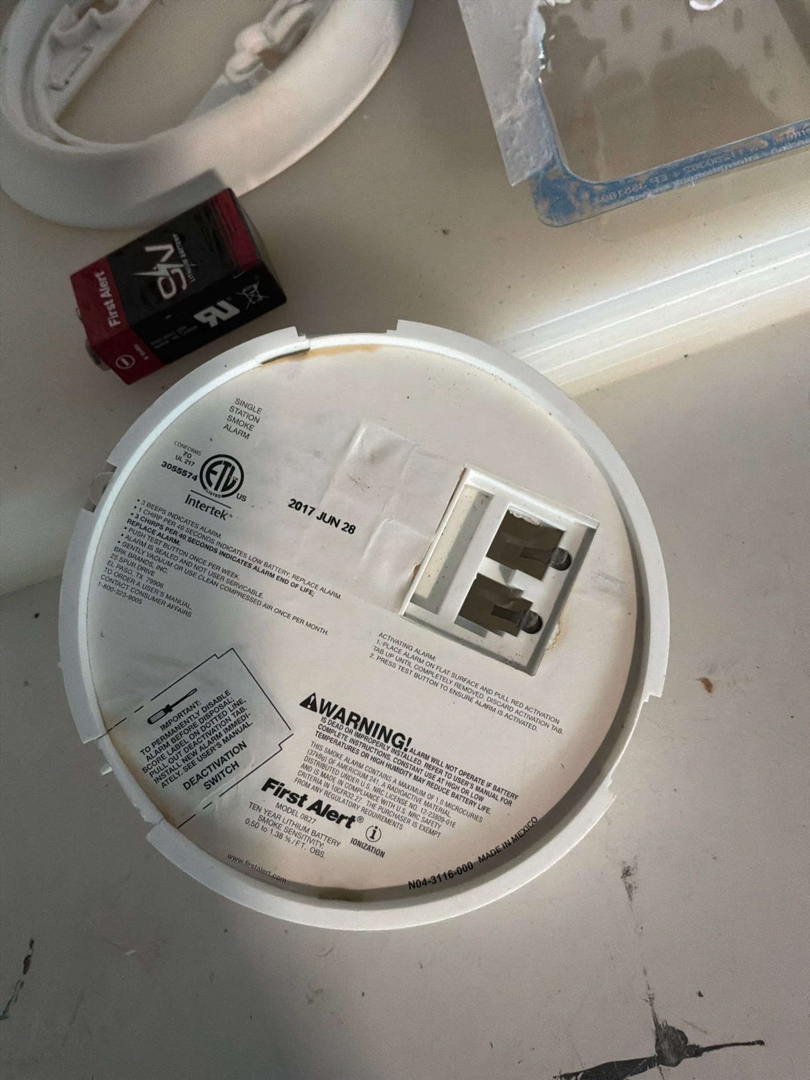 First Alert smoke detector with dated installation label showing June 2017, indicating obsolete detector potentially requiring replacement.