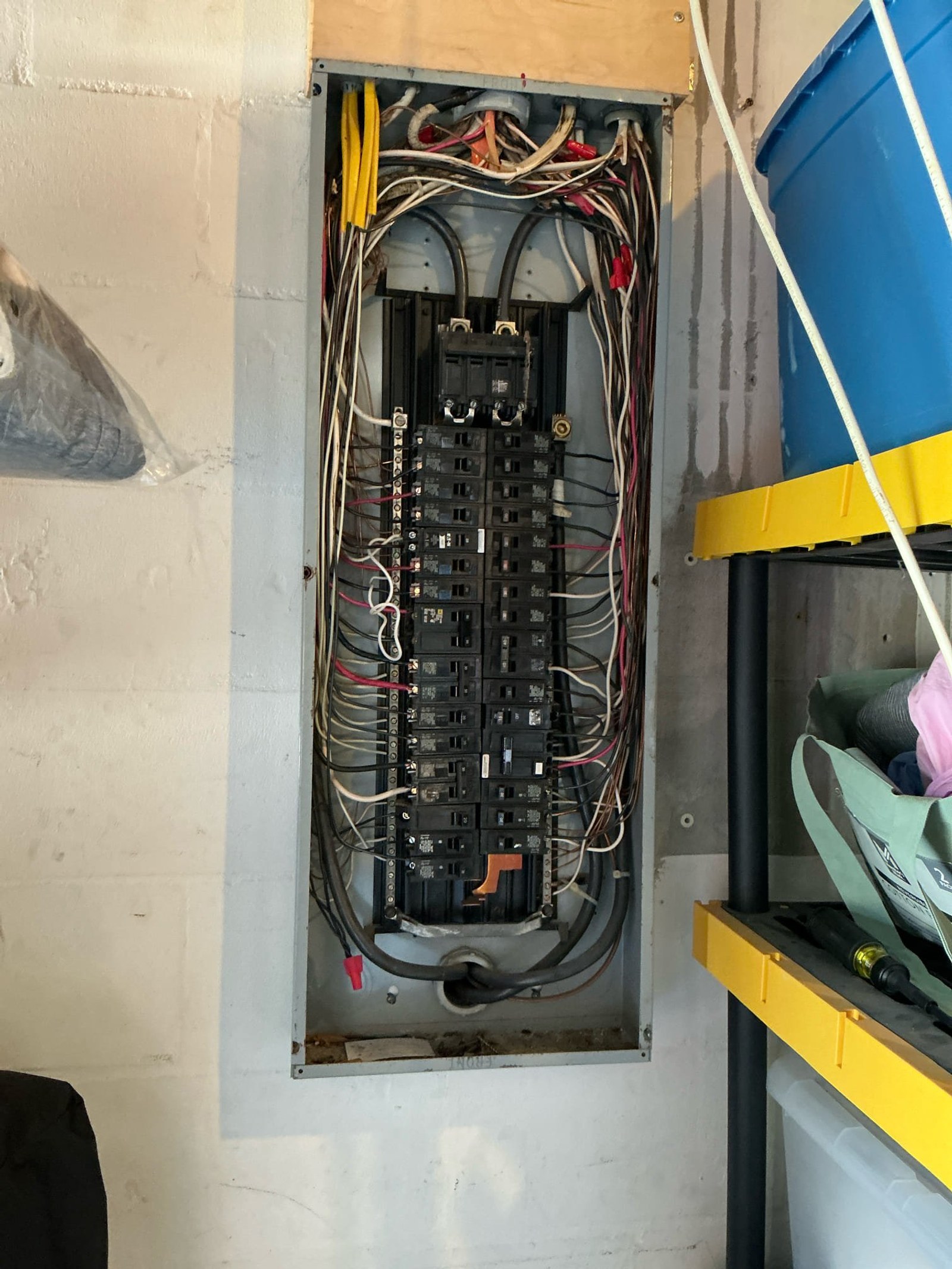Panel interior showing main breaker and feeder circuits with disorganized wire routing and multiple connection points.