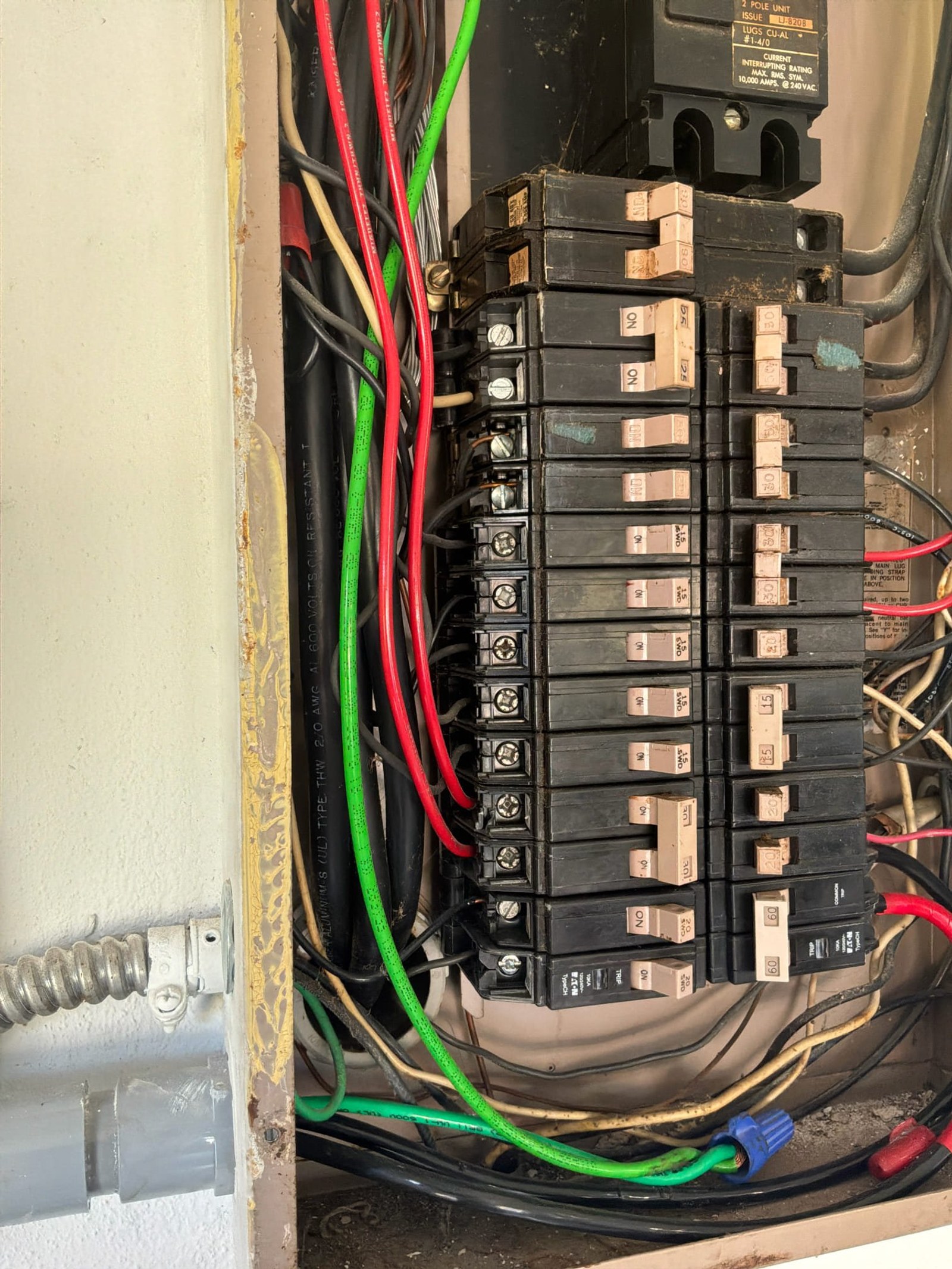 Close-up of panel breaker bank showing standard single-pole breakers without evidence of arc-fault protection devices.