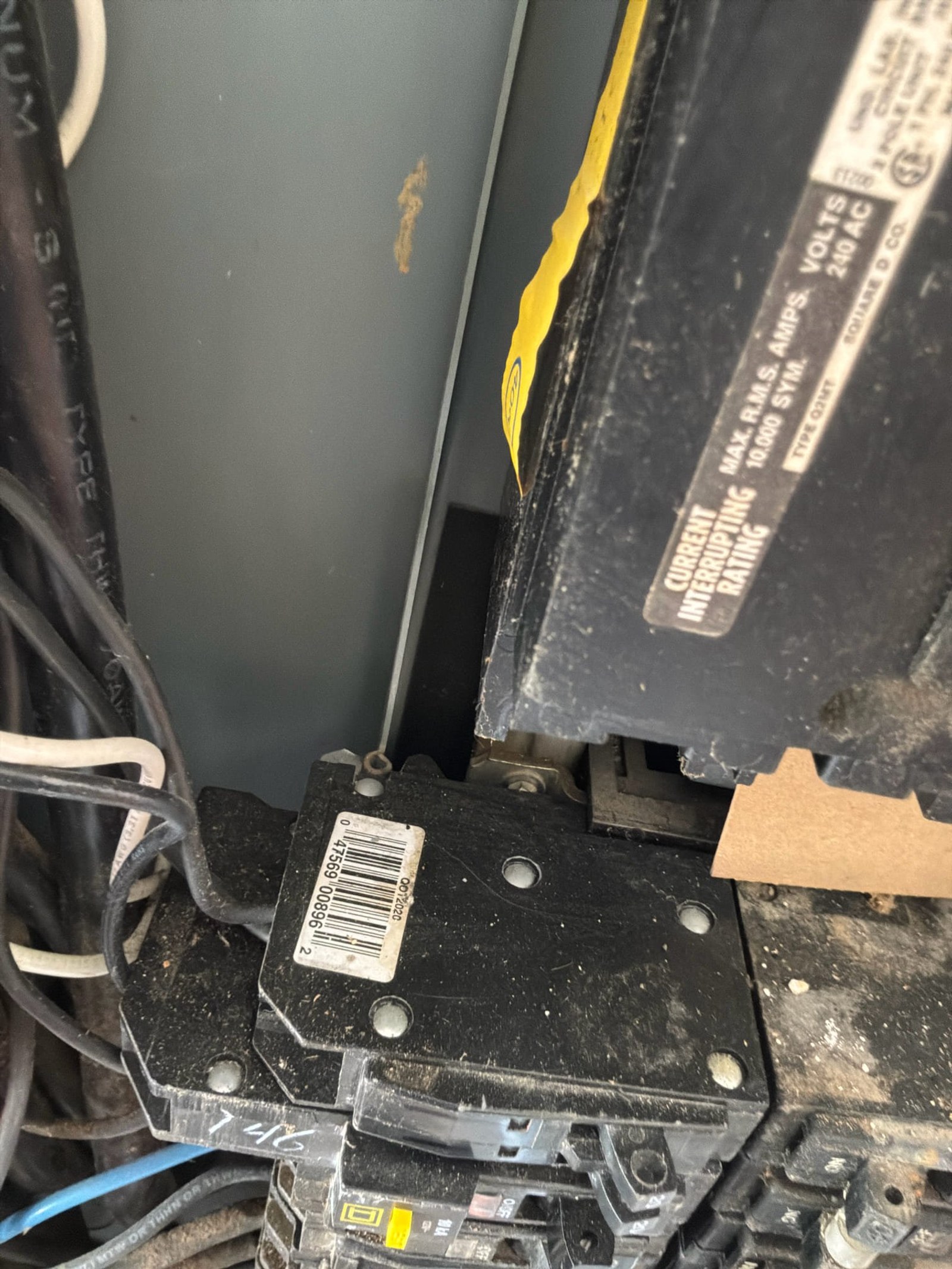 Close-up of main breaker showing wear and corrosion on disconnected main breaker assembly.